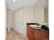 Well lit bathroom with tiled floors, dark granite countertop, white sink and cabinets at 975 N Lincoln St # 10A, Denver, CO 80203