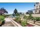 A lovely outdoor garden area featuring a water fountain, colorful flowers, and manicured greenery in a rooftop setting at 975 N Lincoln St # 10A, Denver, CO 80203