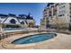 Rooftop hot tub and swimming pool with lounge chairs and building in the background at 975 N Lincoln St # 10A, Denver, CO 80203