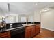 Kitchen with sleek, black appliances complementing the rich wood cabinets at 975 N Lincoln St # 10A, Denver, CO 80203