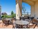 Outdoor patio area with patio furniture, grill, and mature landscaping with blue sky above at 975 N Lincoln St # 10A, Denver, CO 80203