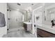 Modern bathroom with a glass-enclosed shower, sleek vanities, and elegant tile work, offering a spa-like experience at 1345 S Ivy Way, Denver, CO 80224