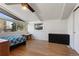 Bright bedroom with hardwood floors, vaulted ceilings, and multiple windows offering plenty of natural light at 1345 S Ivy Way, Denver, CO 80224