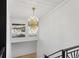 Entryway featuring modern gold chandelier and a staircase leading to the upper level at 1345 S Ivy Way, Denver, CO 80224