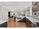 Spacious kitchen with a center island, stainless appliances, and modern finishes, connecting to a dining and living area at 1345 S Ivy Way, Denver, CO 80224