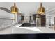Modern kitchen with stainless steel appliances, white countertops, and stylish lighting at 1345 S Ivy Way, Denver, CO 80224