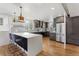 Modern kitchen with stainless steel appliances, white countertops and dark cabinets at 1345 S Ivy Way, Denver, CO 80224