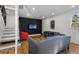 Modern living room with a black accent wall, hardwood floors, and stylish seating at 1345 S Ivy Way, Denver, CO 80224
