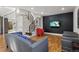 Stylish living room featuring hardwood floors, modern staircase, and a sleek entertainment center at 1345 S Ivy Way, Denver, CO 80224
