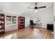 Office with hardwood floors and vaulted ceiling featuring built in bookshelves and a large window at 1345 S Ivy Way, Denver, CO 80224