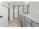 Bathroom featuring a dual sink vanity, black fixtures, and a glass enclosed shower at 20530 E 58Th Ave, Aurora, CO 80019