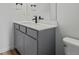 Elegant bathroom vanity with gray cabinets, a white countertop, and a sleek black faucet at 20530 E 58Th Ave, Aurora, CO 80019