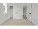 Bedroom featuring neutral carpet, closet and an open doorway at 20530 E 58Th Ave, Aurora, CO 80019
