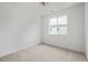 Bedroom with neutral carpet, white walls, and bright window at 20530 E 58Th Ave, Aurora, CO 80019