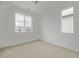 Bright bedroom boasts neutral carpeting and two windows offering natural light at 20530 E 58Th Ave, Aurora, CO 80019