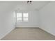 Bright bedroom featuring neutral carpet, white walls, and abundant natural light from the two windows at 20530 E 58Th Ave, Aurora, CO 80019