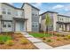 Exterior view of gray townhomes with stone accents and manicured front yards at 20530 E 58Th Ave, Aurora, CO 80019