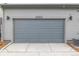Attached garage door with address number, providing convenient parking and storage at 20530 E 58Th Ave, Aurora, CO 80019