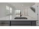 Modern kitchen island with sink and faucet, offering a view of the bright living area and staircase at 20530 E 58Th Ave, Aurora, CO 80019