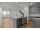 Spacious open kitchen connected to the living area, featuring a large island with stainless steel dishwasher at 20530 E 58Th Ave, Aurora, CO 80019