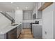 Stylish kitchen boasts gray cabinets, stainless steel appliances, and a central island with a sink at 20530 E 58Th Ave, Aurora, CO 80019