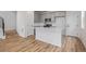 Open kitchen featuring gray cabinets, stainless steel appliances, and a spacious white island at 20530 E 58Th Ave, Aurora, CO 80019