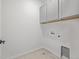 Well-lit laundry room includes convenient overhead cabinets at 20530 E 58Th Ave, Aurora, CO 80019
