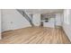 Spacious living area with modern floors, staircase and an open concept connecting to the kitchen at 20530 E 58Th Ave, Aurora, CO 80019