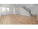 Spacious living room with wood floors, large windows, staircase and bright white walls at 20530 E 58Th Ave, Aurora, CO 80019