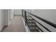 Hallway and staircase with metal railing at 20530 E 58Th Ave, Aurora, CO 80019