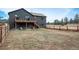 Spacious backyard with a deck, fenced perimeter, and a dog house under the elevated deck at 28364 Tresine Dr, Evergreen, CO 80439