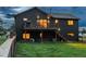 Backyard with a wood fence, luscious green grass, and home with a deck at 28364 Tresine Dr, Evergreen, CO 80439