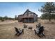 Inviting backyard with a fire pit surrounded by Adirondack chairs, perfect for outdoor relaxation and entertaining at 28364 Tresine Dr, Evergreen, CO 80439