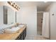 Updated bathroom with a double sink vanity with modern fixtures, and a shower at 28364 Tresine Dr, Evergreen, CO 80439