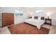 Bright bedroom with a large window, neutral decor, and hardwood floors at 28364 Tresine Dr, Evergreen, CO 80439