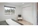 Well-lit bedroom with a large window, comfortable chair, and closet space at 28364 Tresine Dr, Evergreen, CO 80439