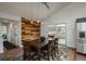 Dining area featuring a wooden table set, modern lighting, and a door to the outside deck at 28364 Tresine Dr, Evergreen, CO 80439