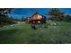 Beautiful two-story home with deck and cozy fire pit on a large grassy lot at 28364 Tresine Dr, Evergreen, CO 80439