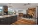 Open-concept kitchen featuring granite island flowing into a dining area and a stone fireplace at 28364 Tresine Dr, Evergreen, CO 80439