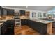 Modern kitchen featuring stainless steel appliances, granite countertops, and stylish dark cabinetry at 28364 Tresine Dr, Evergreen, CO 80439