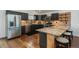Modern kitchen with stainless steel appliances, dark cabinets, and granite countertops at 28364 Tresine Dr, Evergreen, CO 80439