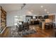Open concept living space featuring a dining area with modern kitchen in the background at 28364 Tresine Dr, Evergreen, CO 80439