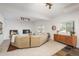 Bright living room with sectional sofa, modern cabinet, and large windows offering outdoor views at 28364 Tresine Dr, Evergreen, CO 80439