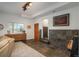 Bright living room featuring tiled flooring, sectional sofa, a cabinet, and a view of the outdoor landscape at 28364 Tresine Dr, Evergreen, CO 80439
