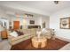 Spacious living room with a cozy sectional sofa, unique center table, and neutral tones at 28364 Tresine Dr, Evergreen, CO 80439