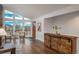 Sunlit living area with views, complemented by a sliding barn door buffet and stylish decor at 28364 Tresine Dr, Evergreen, CO 80439