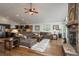 Spacious living area showcasing a stone fireplace, open layout, and seamless integration with the kitchen at 28364 Tresine Dr, Evergreen, CO 80439
