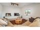 Inviting living room with a large sofa, decorative pieces, and a view to nature at 28364 Tresine Dr, Evergreen, CO 80439