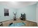 Home gym with workout equipment, blue walls, and natural light from a window at 11346 E 27Th Ave, Denver, CO 80238