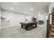 Spacious basement featuring a pool table, bar area, and comfortable carpeting, perfect for entertaining at 11346 E 27Th Ave, Denver, CO 80238